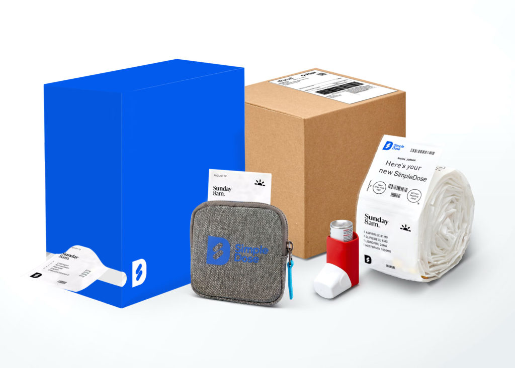 Simpledose dispenser box, travel pouch and sachets with the mailing box in background